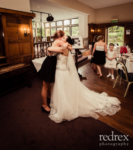 Bridesmaids and Bride hugging